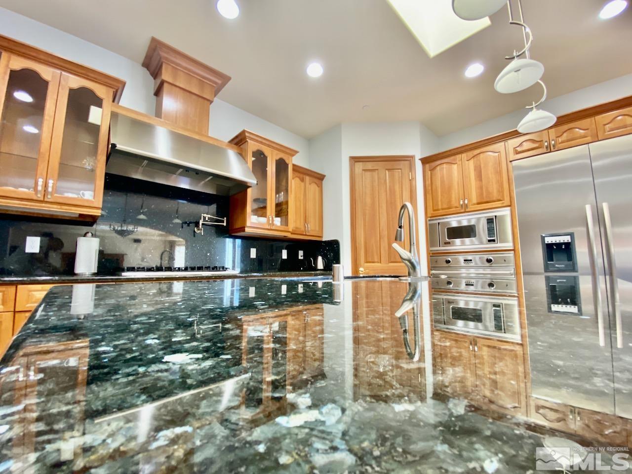 3807 Paradise View Carson City, NV 89703 - Photo 16 of 40 a kitchen with stainless steel appliances granite countertop a refrigerator and a sink