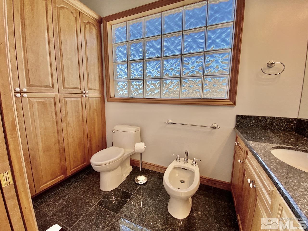 3807 Paradise View Carson City, NV 89703 - Photo 24 of 40 a bathroom with a toilet a sink and a window