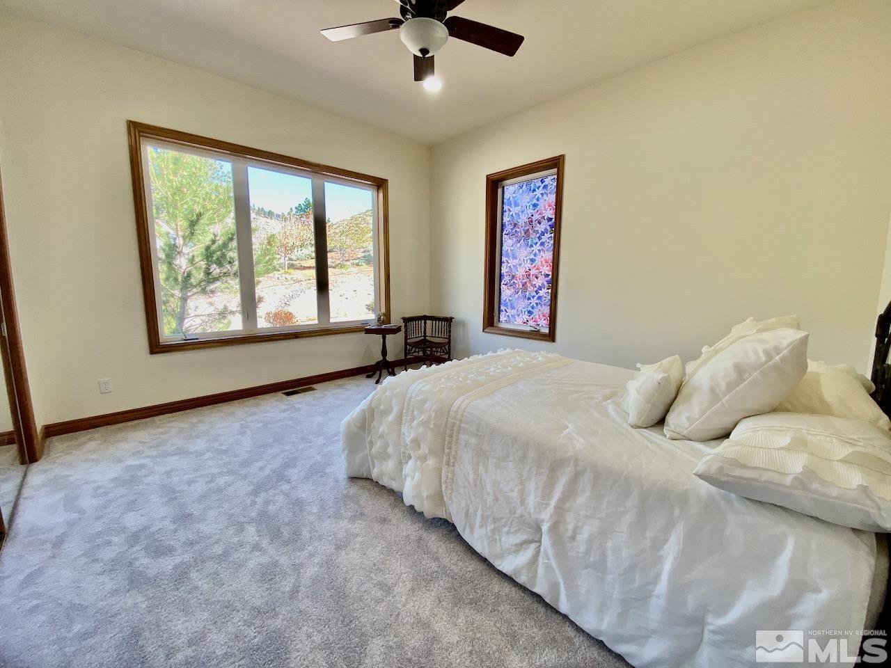 3807 Paradise View Carson City, NV 89703 - Photo 25 of 40 a bedroom with a bed and a large window