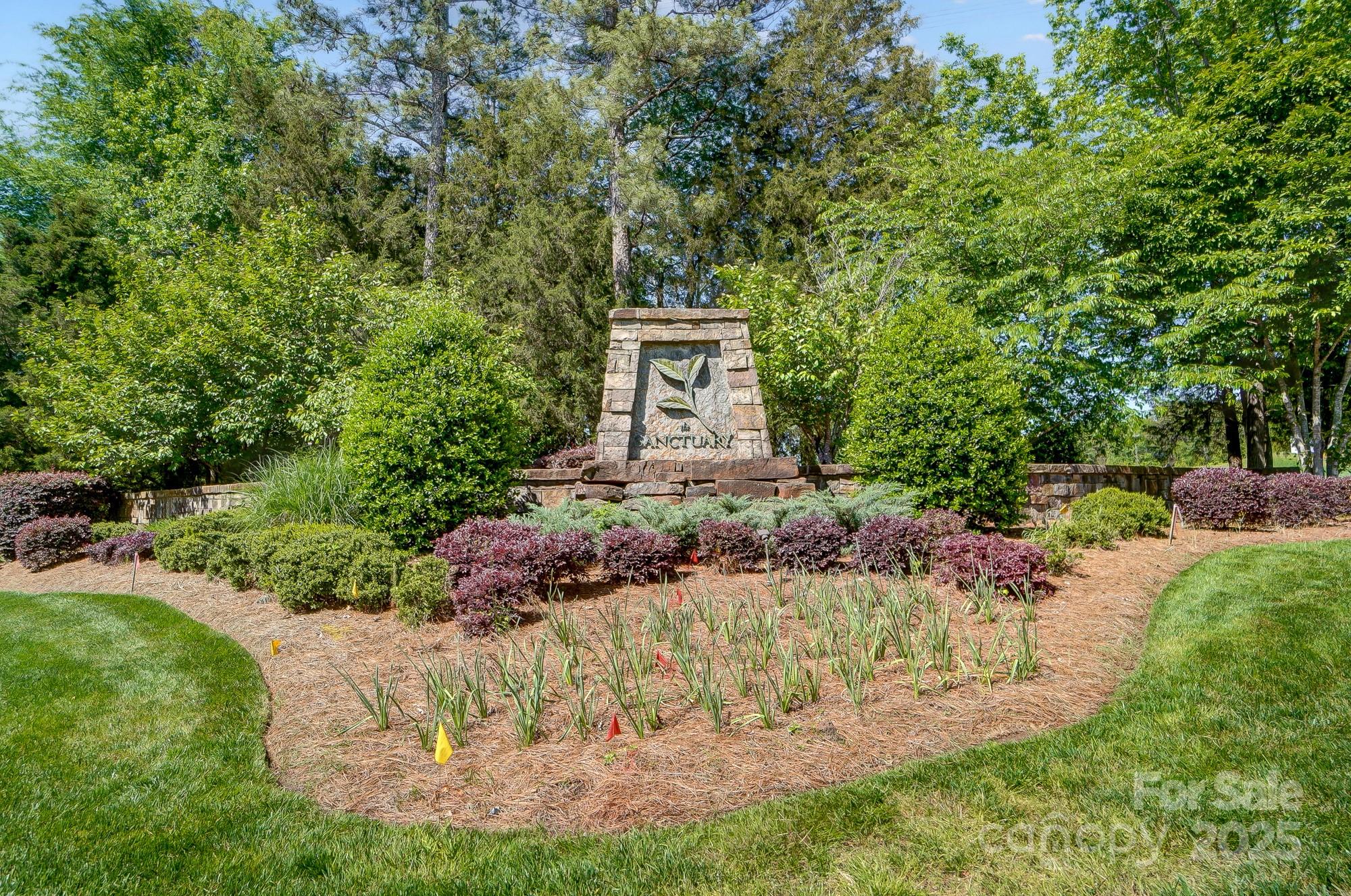a garden with trees in the background