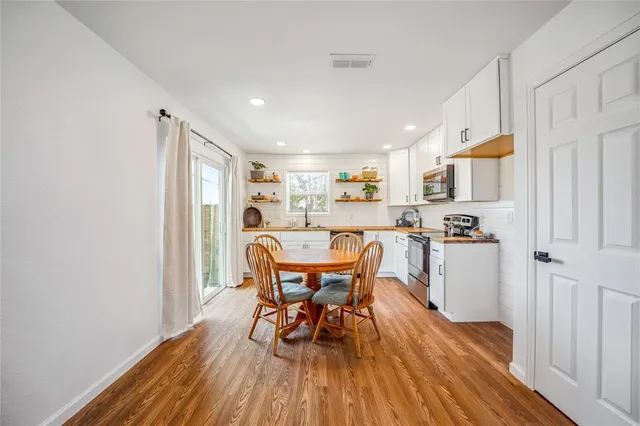 a view of a dining room with furniture and wooden floor