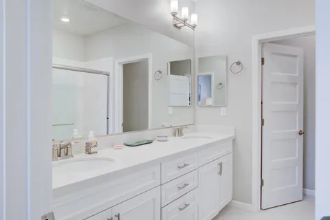 a bathroom with a sink double vanity and a mirror