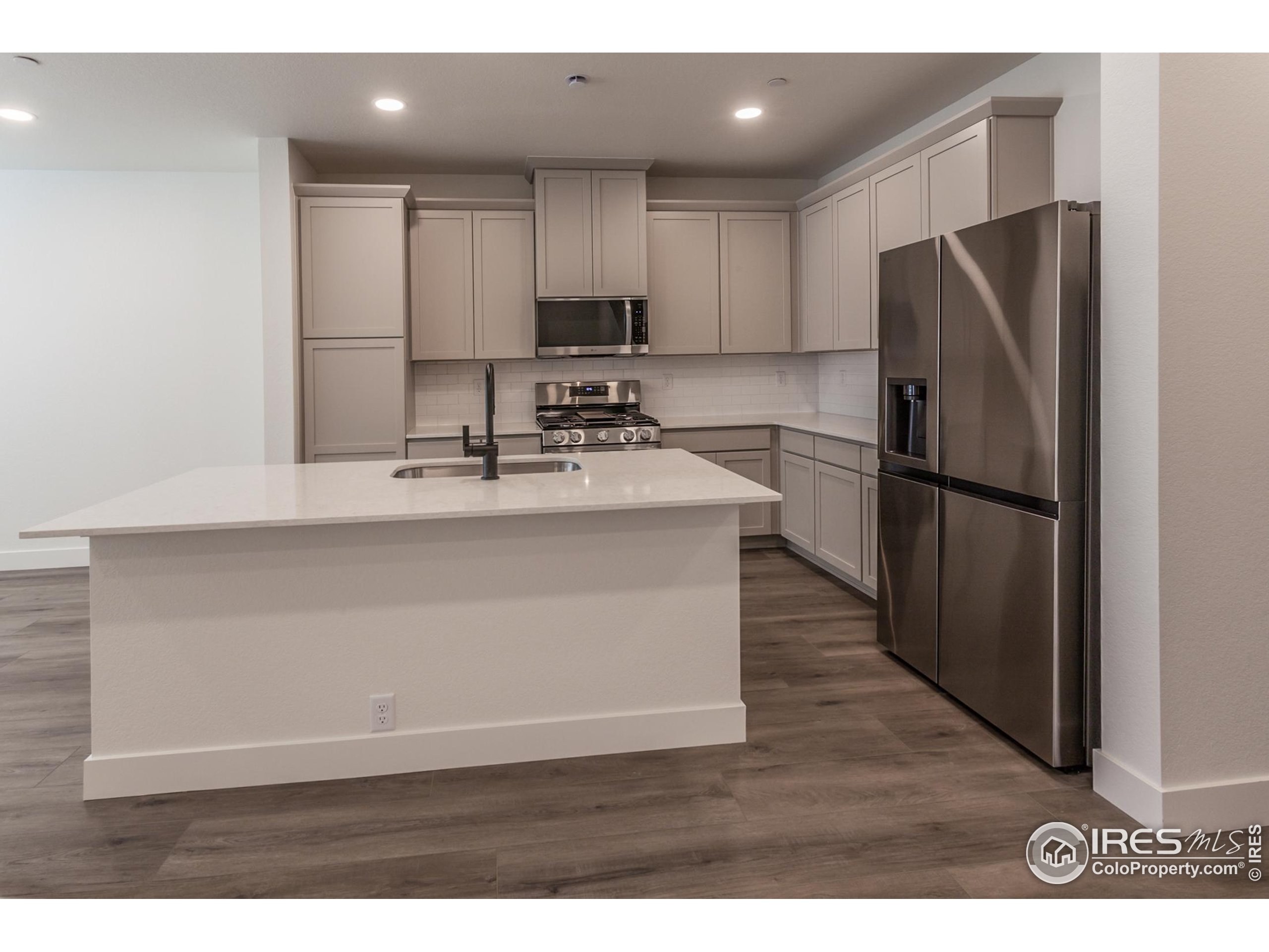 4909 Autumn Leaf Drive Timnath, CO 80547 - Photo 13 of 34 a kitchen with stainless steel appliances granite countertop a refrigerator a sink and a stove