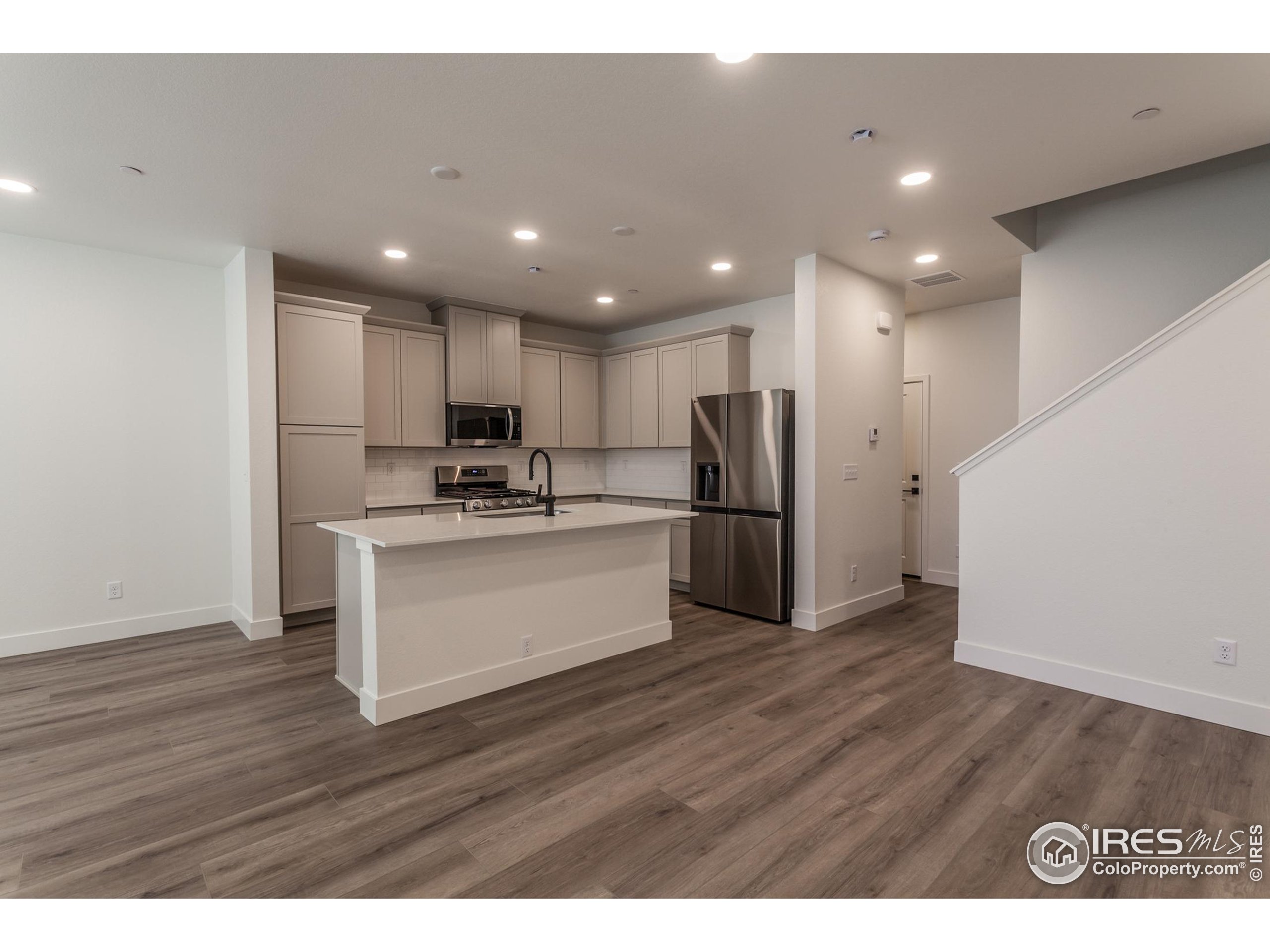4909 Autumn Leaf Drive Timnath, CO 80547 - Photo 16 of 34 a view of kitchen with granite countertop stainless steel appliances refrigerator and microwave
