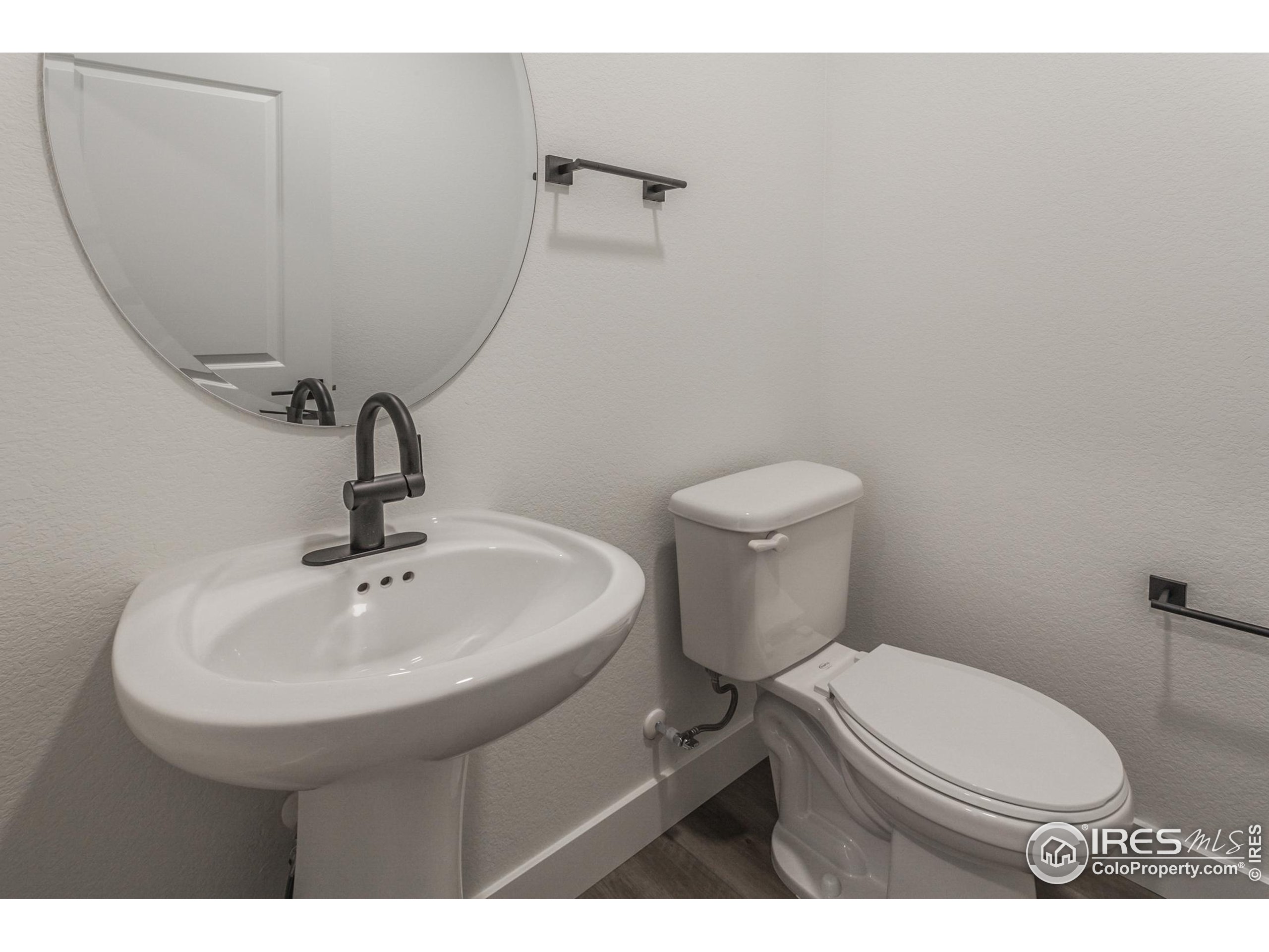 4909 Autumn Leaf Drive Timnath, CO 80547 - Photo 18 of 34 a bathroom with a sink toilet and a mirror