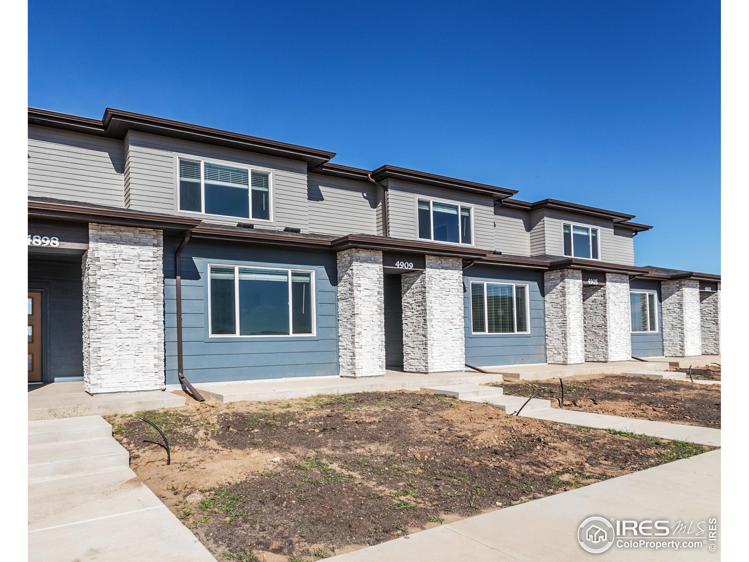 4909 Autumn Leaf Drive Timnath, CO 80547 - Photo 2 of 34 a front view of a house with garage