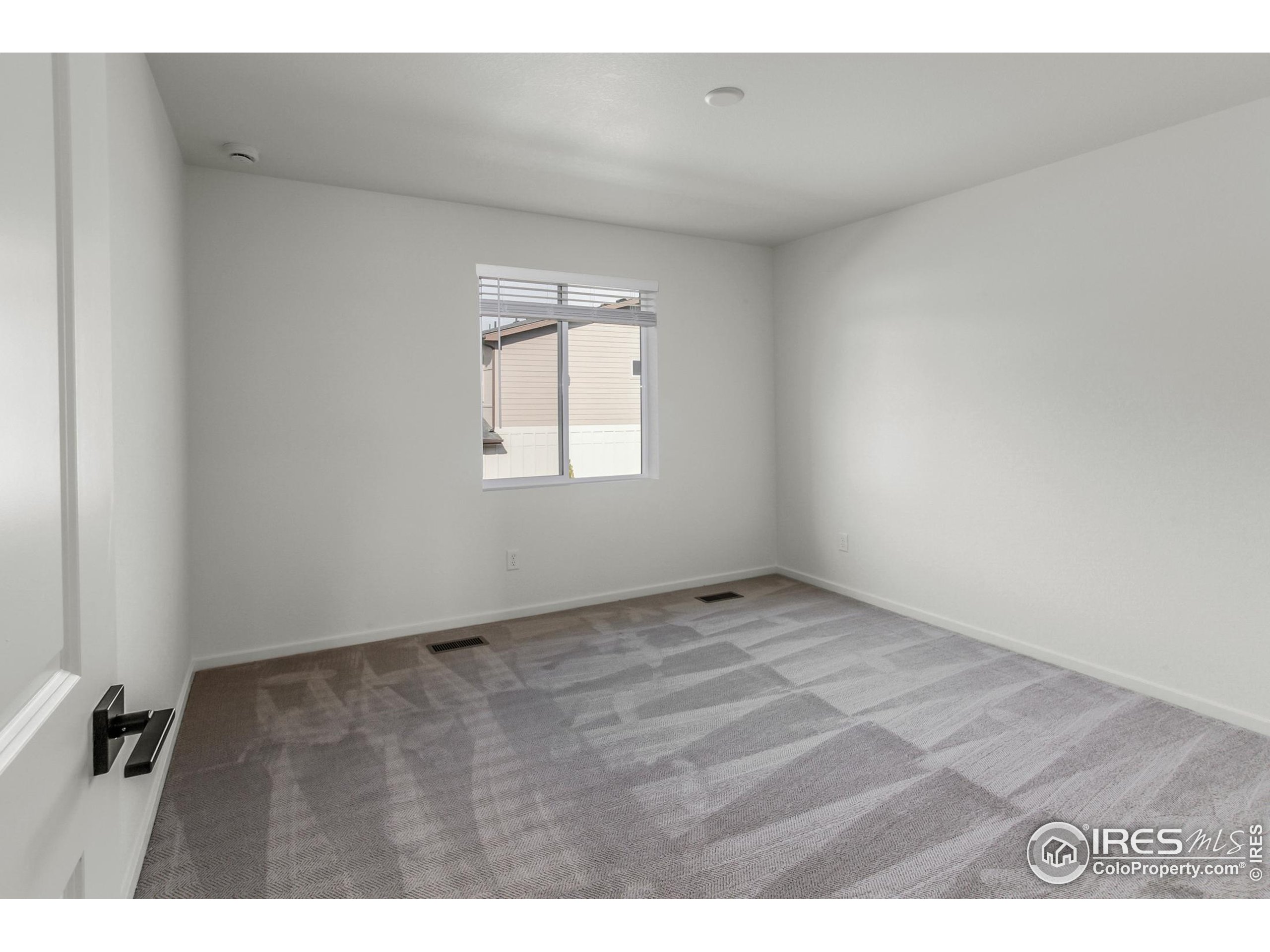 4909 Autumn Leaf Drive Timnath, CO 80547 - Photo 22 of 34 a view of an empty room with a window