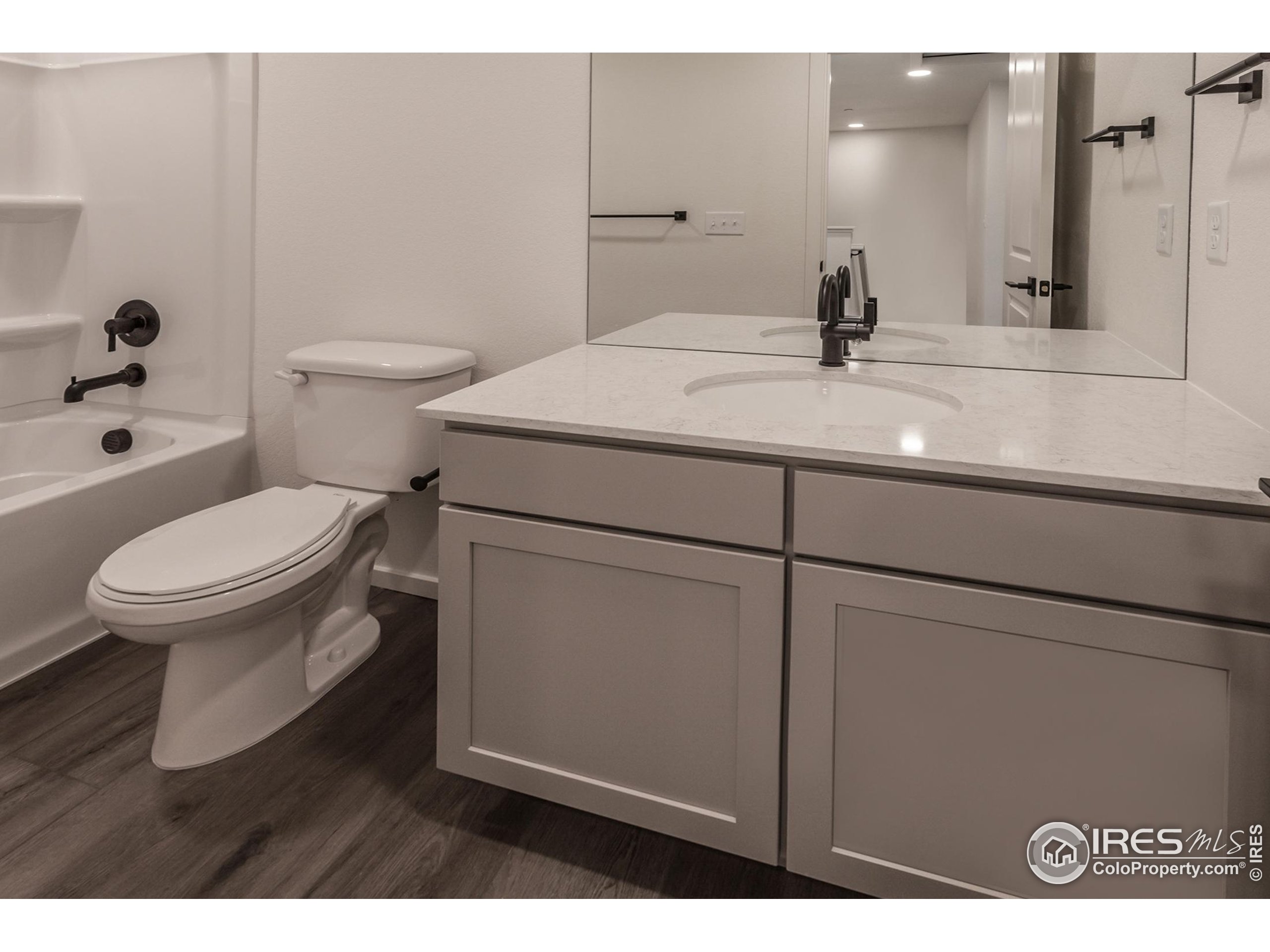4909 Autumn Leaf Drive Timnath, CO 80547 - Photo 27 of 34 a bathroom with a sink toilet and mirror
