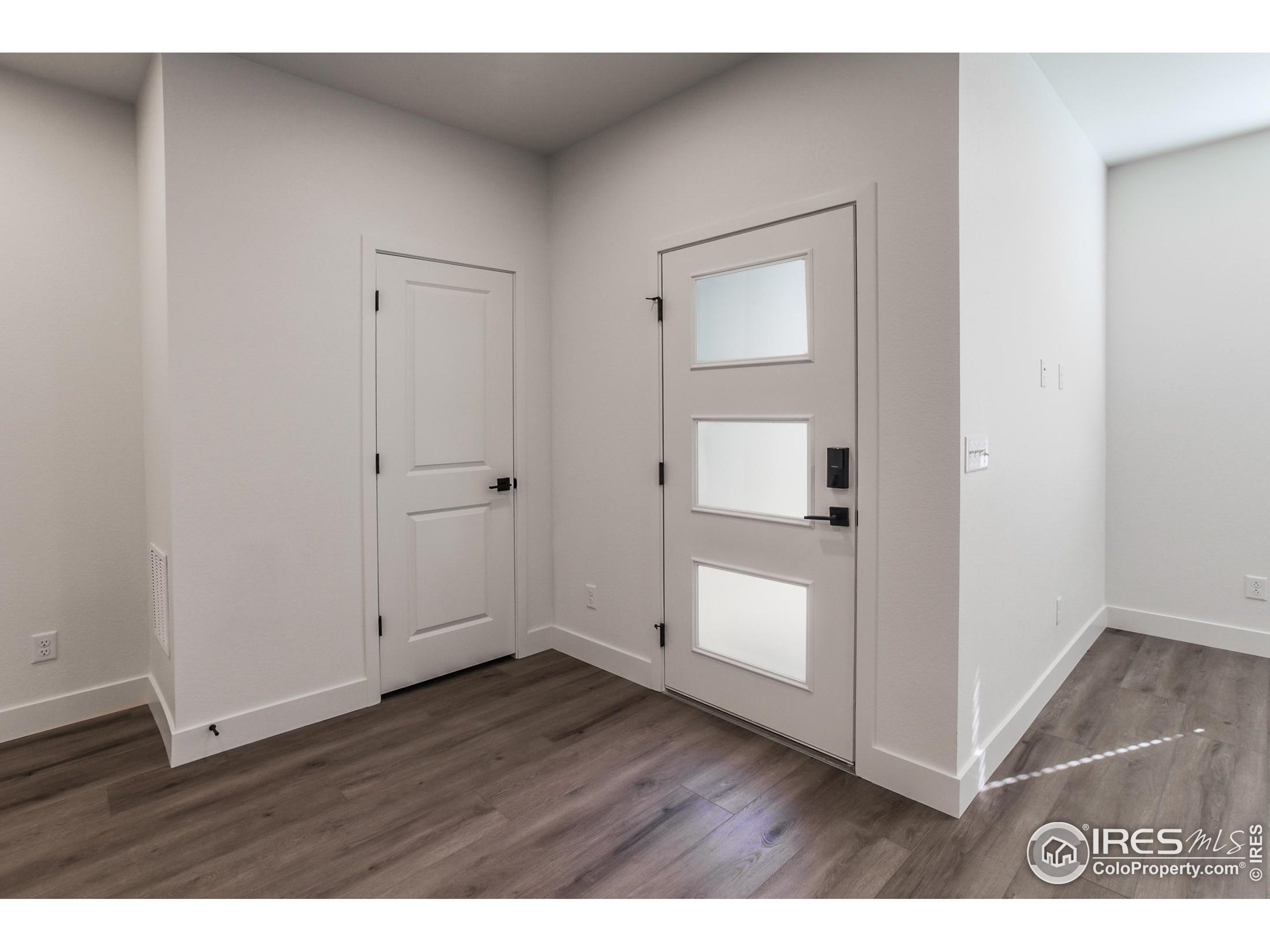 4909 Autumn Leaf Drive Timnath, CO 80547 - Photo 5 of 34 a view of an empty room with wooden floor