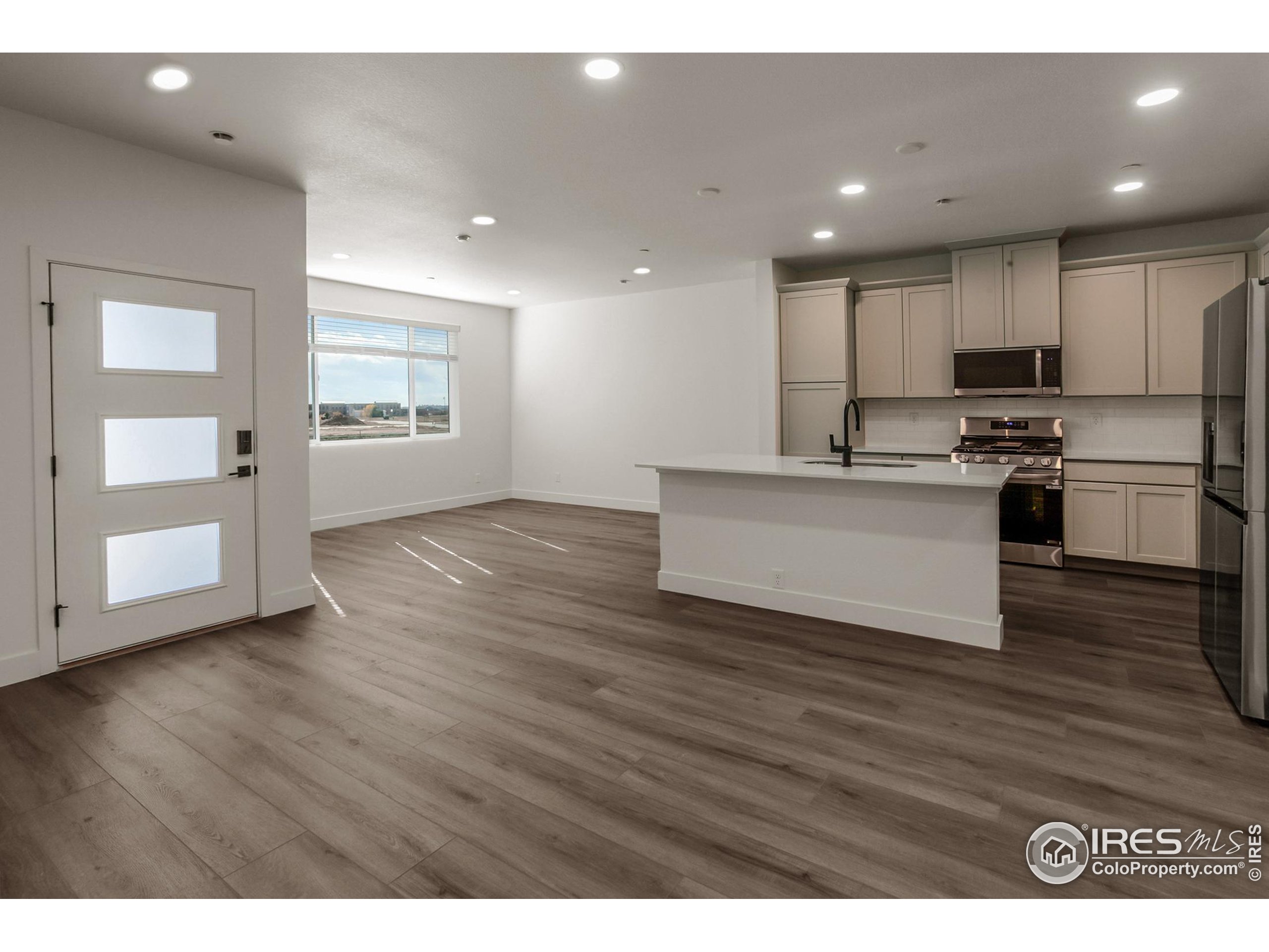 4909 Autumn Leaf Drive Timnath, CO 80547 - Photo 6 of 34 a view of kitchen with wooden floor