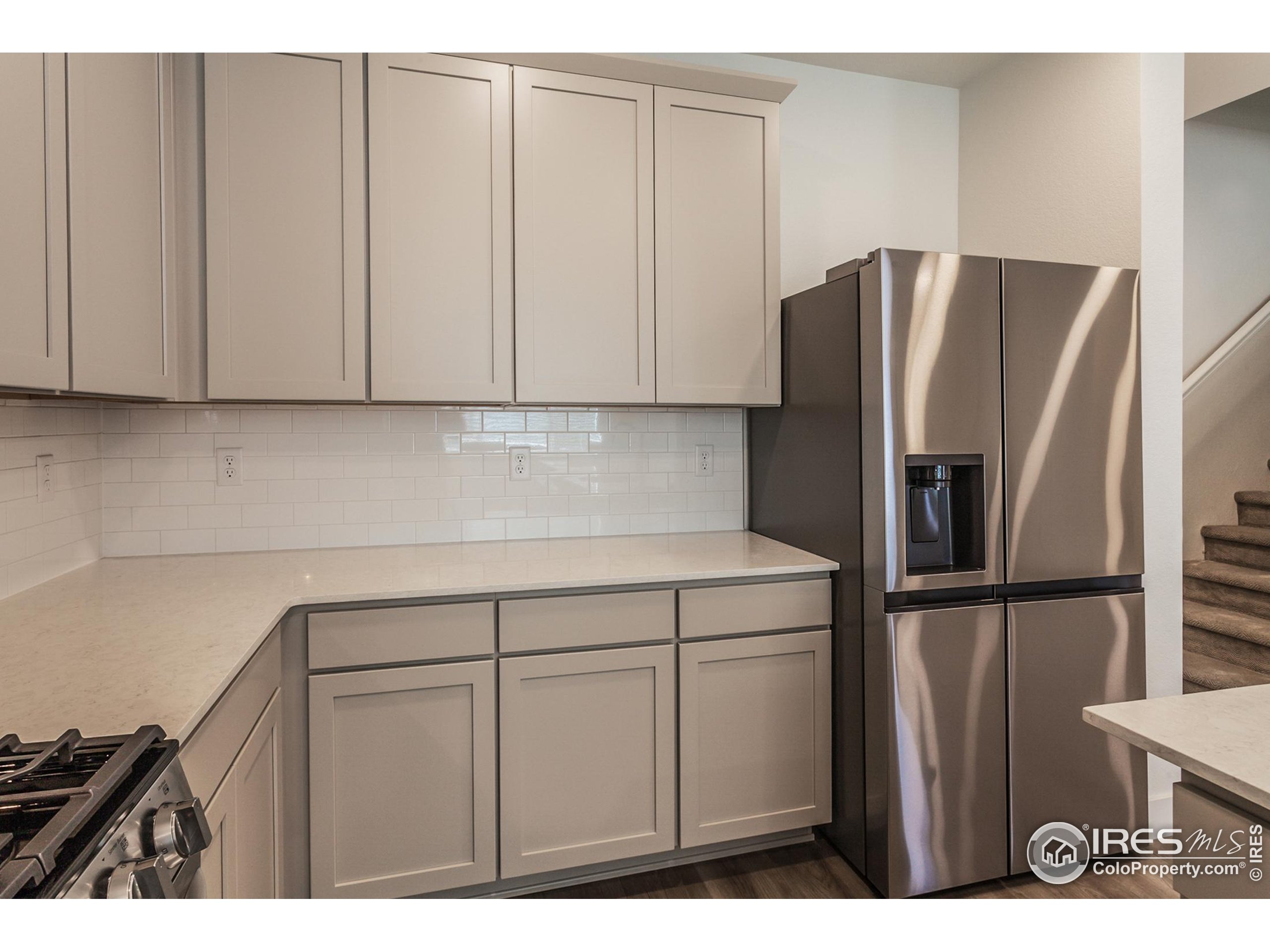 4909 Autumn Leaf Drive Timnath, CO 80547 - Photo 8 of 34 a kitchen with a refrigerator and cabinets