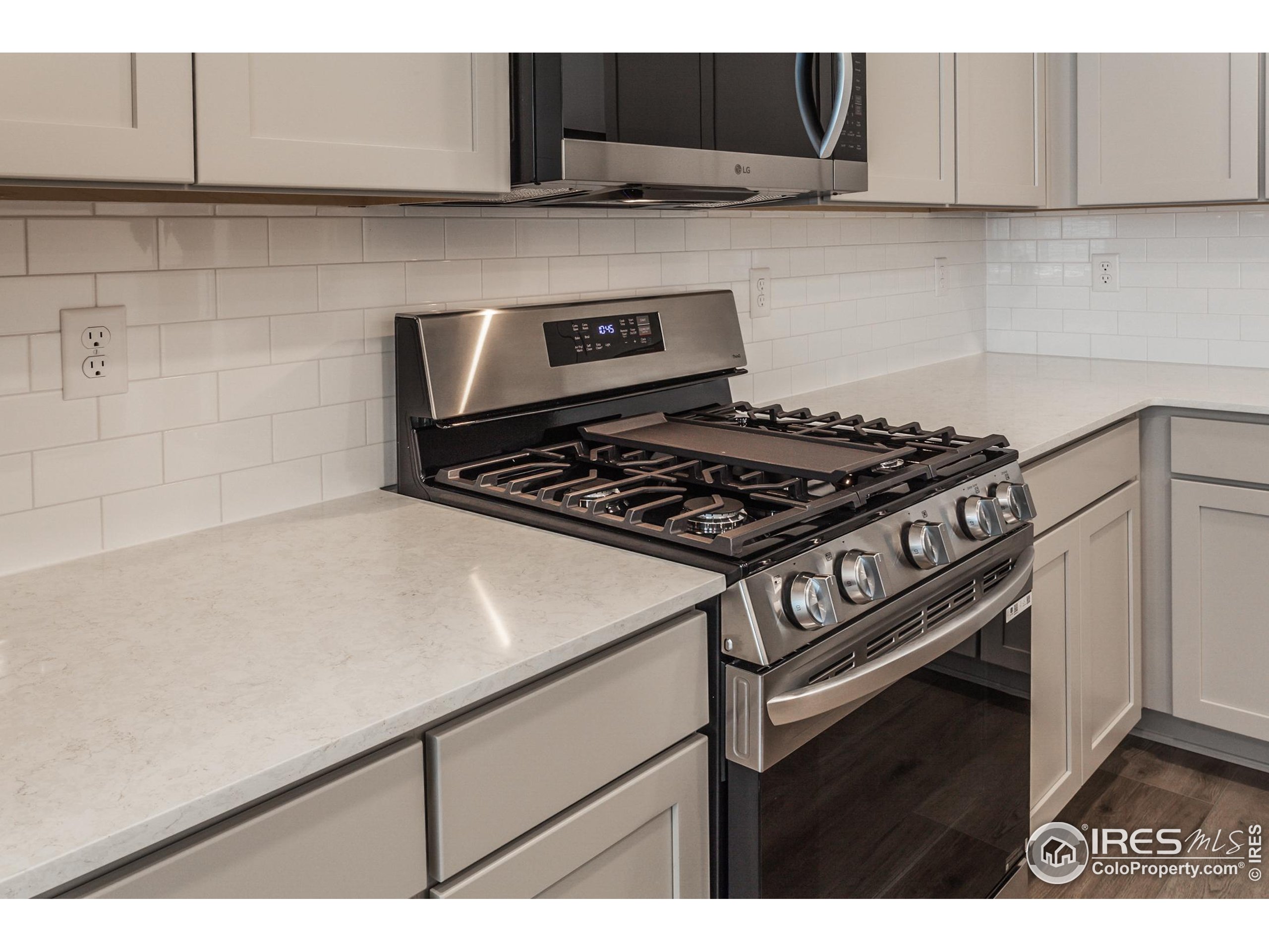 4909 Autumn Leaf Drive Timnath, CO 80547 - Photo 10 of 34 a kitchen with a stove and a microwave