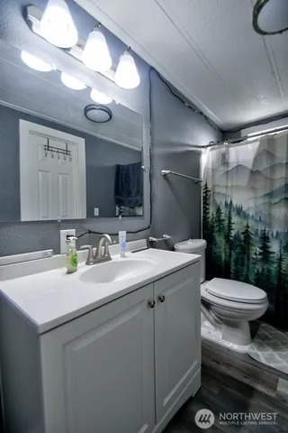 a bathroom with a sink toilet and shower