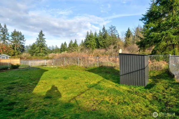 a view of garden with wooden fence