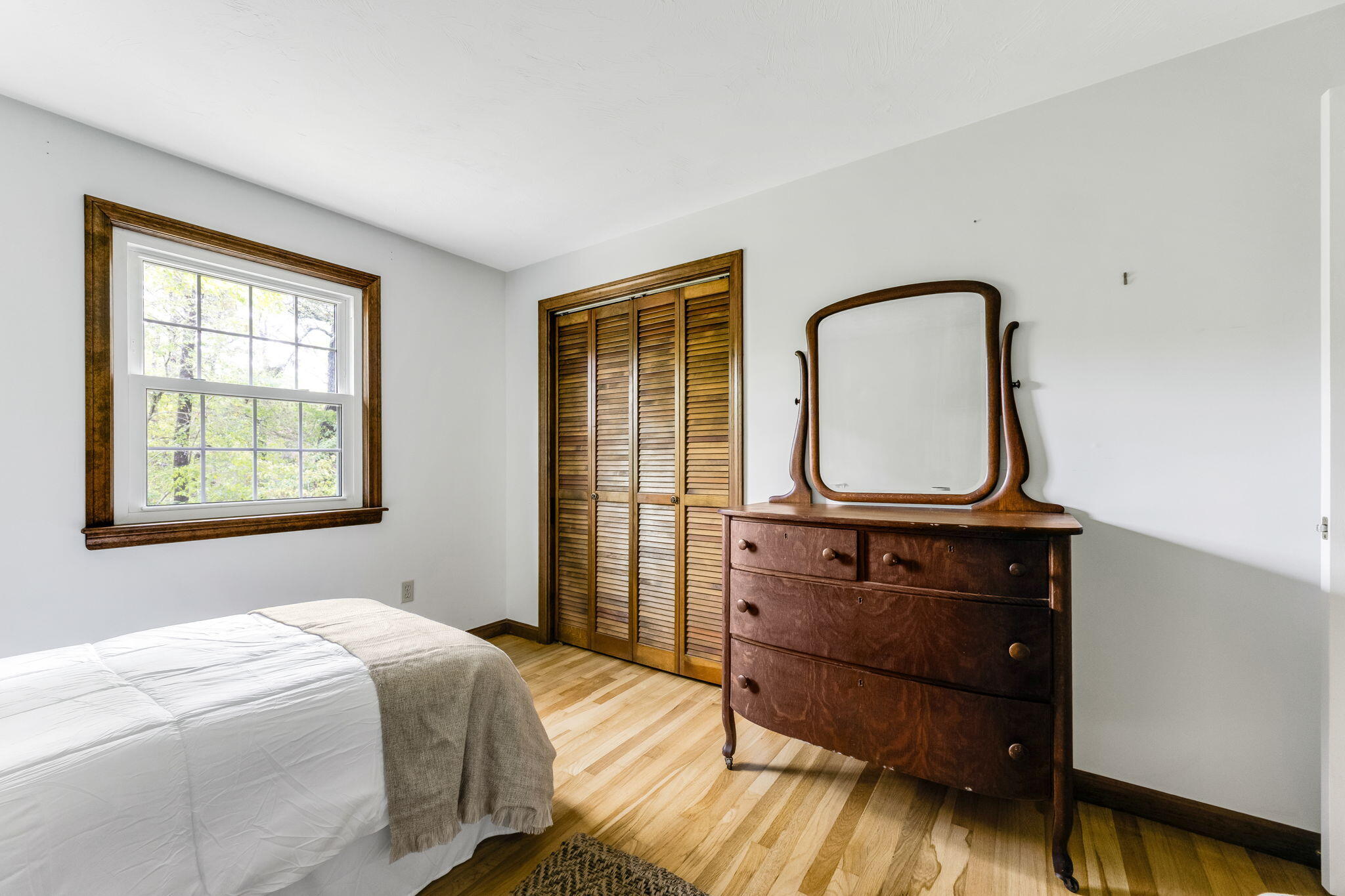 8 Bay Pine Road Harwich, MA 02645 - Photo 17 of 28 a bedroom with a bed a mirror and a window