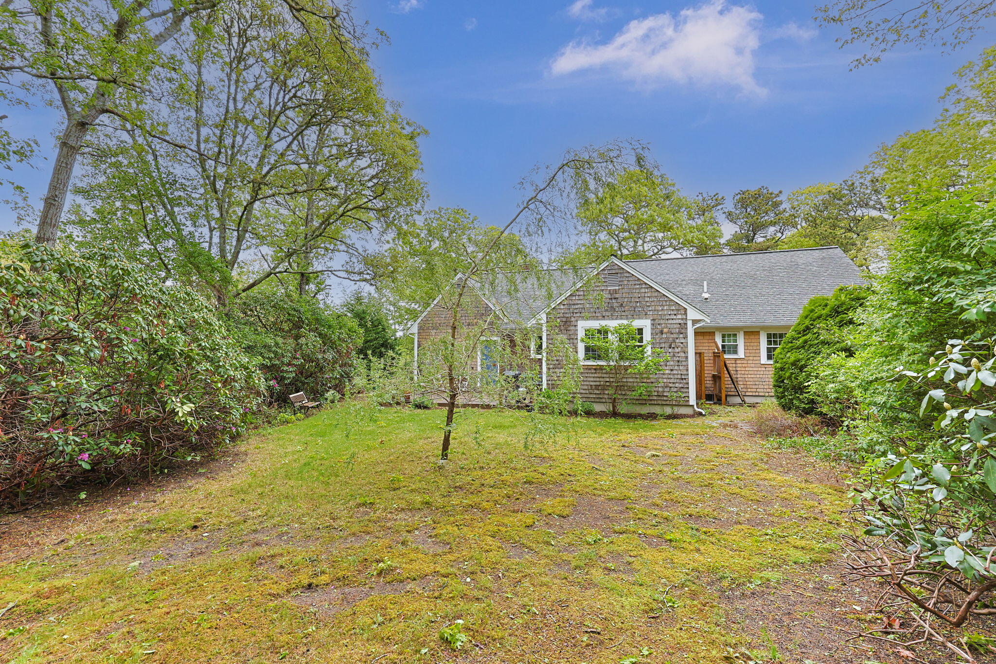 8 Bay Pine Road Harwich, MA 02645 - Photo 26 of 28 a house with green field in front of it