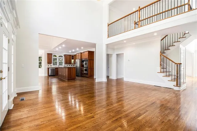 a kitchen with stainless steel appliances kitchen island granite countertop a stove a sink and a microwave