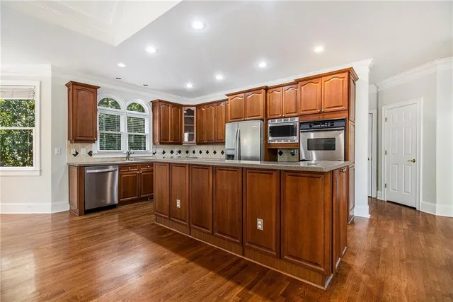 a kitchen with stainless steel appliances granite countertop a sink and a cabinets