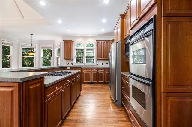 a kitchen with stainless steel appliances granite countertop a sink and a cabinets