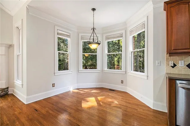 a view of a livingroom with wooden floor and a chandelier