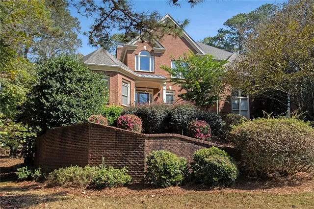 a view of a house with a yard and plants
