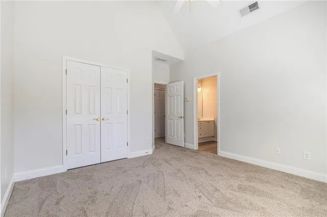 a bathroom with a granite countertop sink a toilet and shower