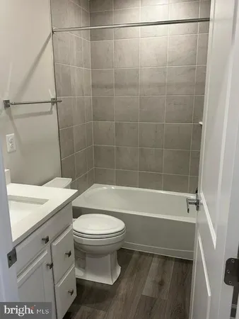 a bathroom with a sink a toilet and bathtub