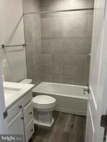 a bathroom with a sink a toilet and bathtub
