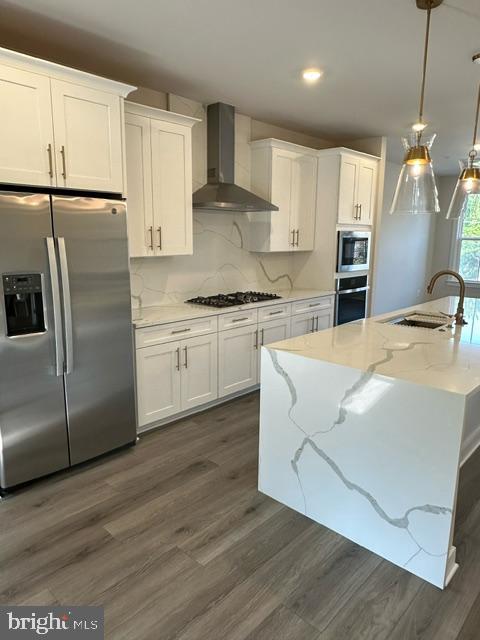 814 South Greenbrier Street Arlington, VA 22204 - Photo 7 of 27 a kitchen with stainless steel appliances granite countertop a sink a stove a refrigerator and island with wooden floor