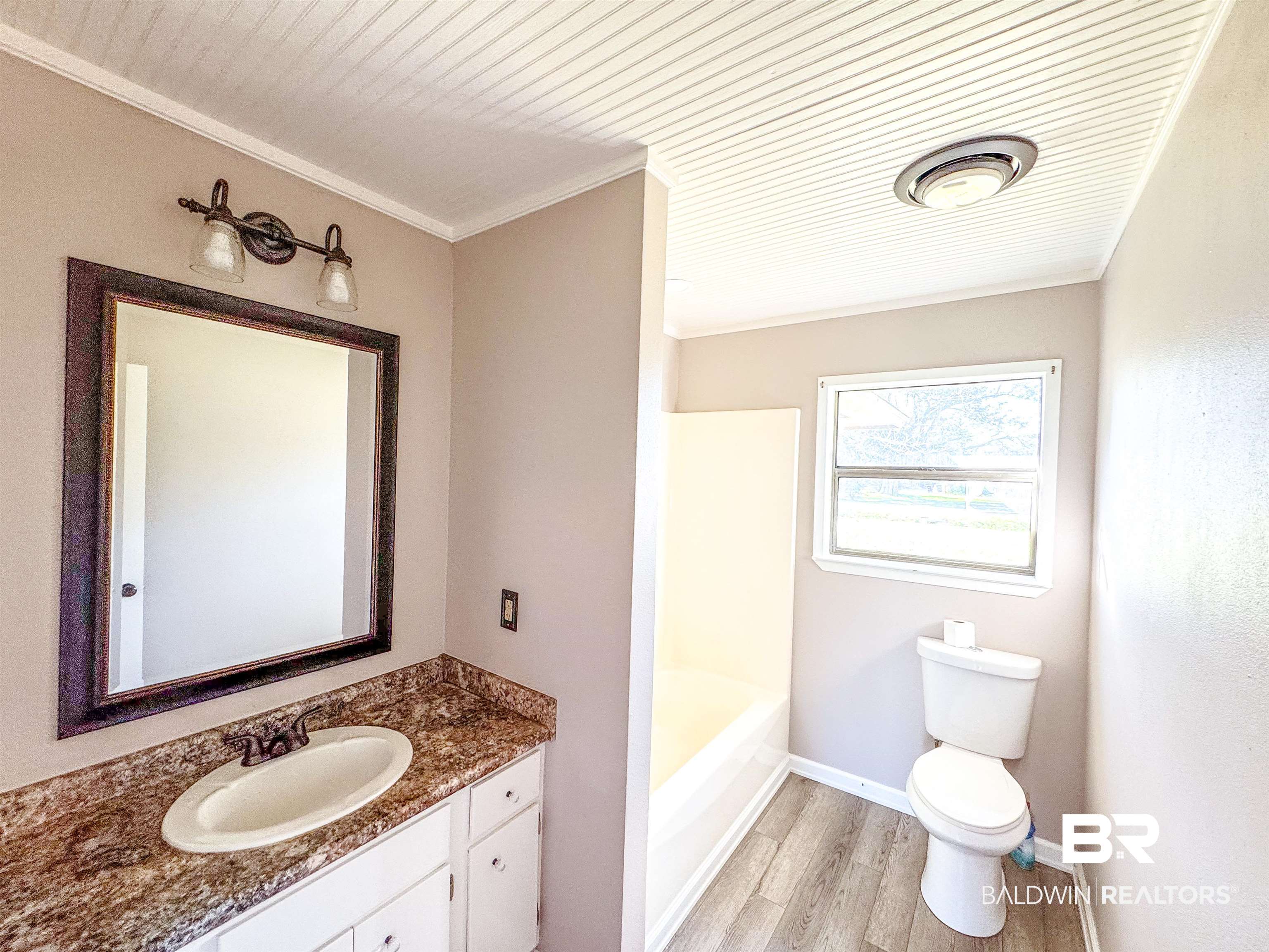 1104 North Pine Street Foley, AL 36535 - Photo 21 of 35 Bathroom with a bathtub, toilet, ornamental molding, vanity, and wood finished floors