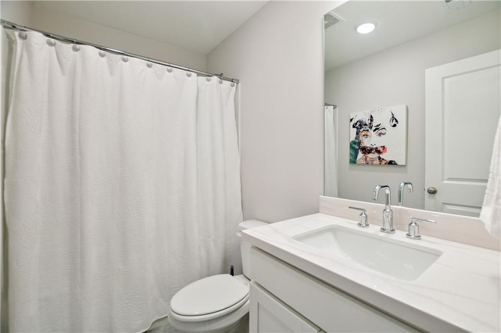 765 Trevett Way Marietta, GA 30066 - Photo 29 of 44 a bathroom with a granite countertop sink toilet and a mirror