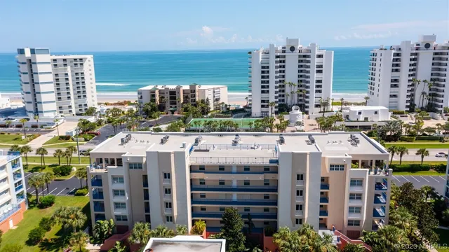 a living room with furniture and a large window with garden view
