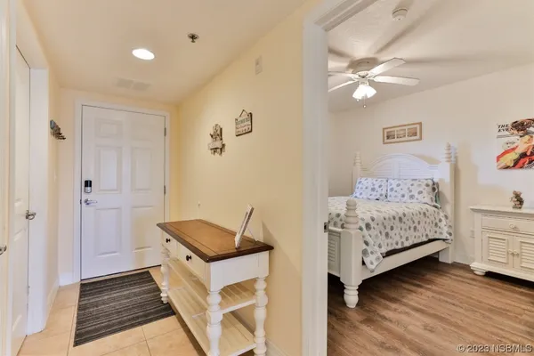 a living room with furniture a flat screen tv and a large window