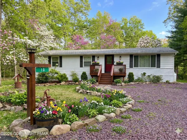 a view of a house with a yard and garden