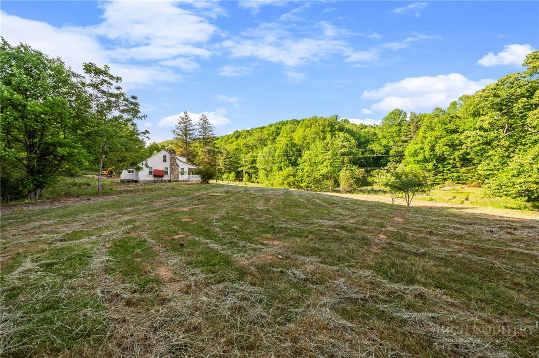 657 Lawrence Greene Road Deep Gap, NC 28618 - Photo 7 of 25 a view of yard with swimming pool and green space