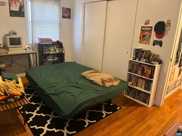 a bedroom with a bed and a book shelf