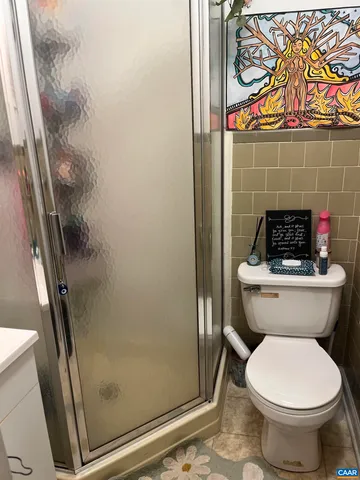a bathroom with a toilet and shower