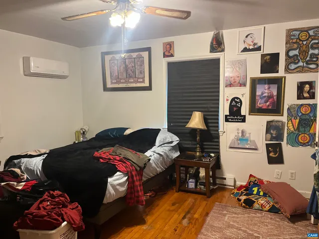 a bedroom with bed and a chandelier