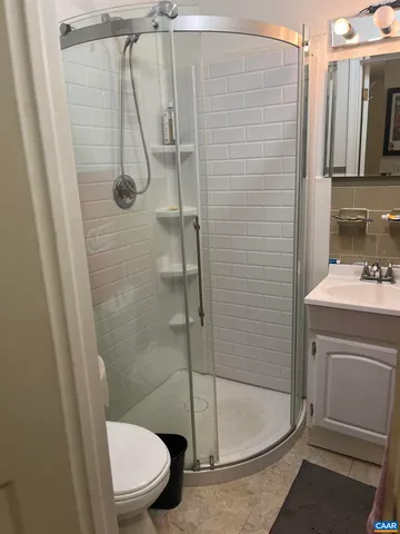 a bathroom with a shower a toilet and a sink