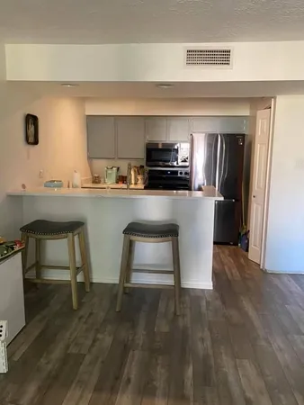 a kitchen with a sink cabinets and stainless steel appliances