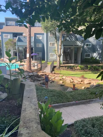 a view of swimming pool with outdoor seating and a garden