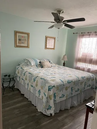 a bedroom with bed and wooden floor