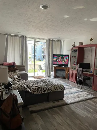 a bedroom with furniture and a flat screen tv