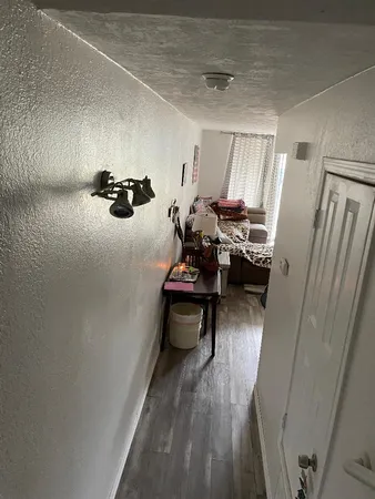 a view of living room with furniture and wooden floor