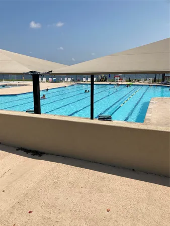 a view of swimming pool from a balcony