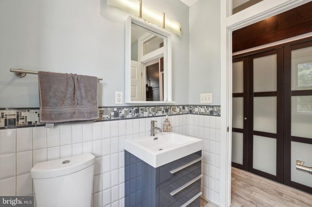 a bathroom with a sink toilet and mirror