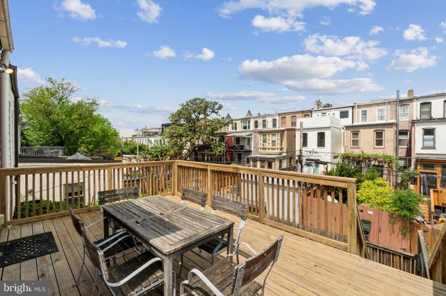 a view of a deck with two chairs and table on the wooden floor