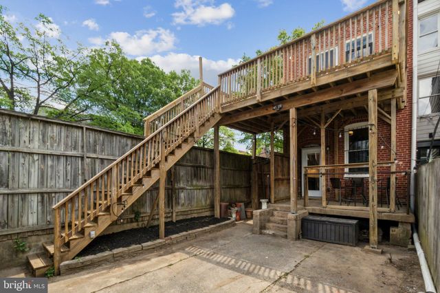 a front view of a house with glass windows and a table