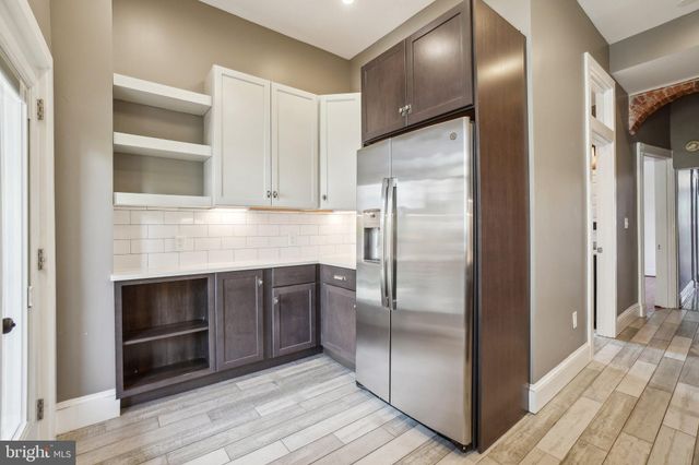 a kitchen with a refrigerator and microwave