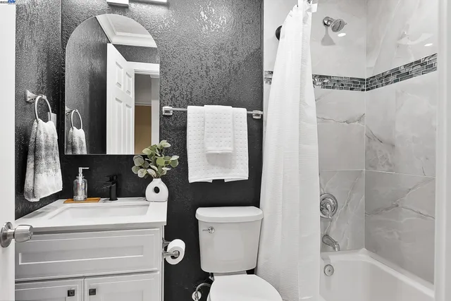 a bathroom with a toilet sink and shower